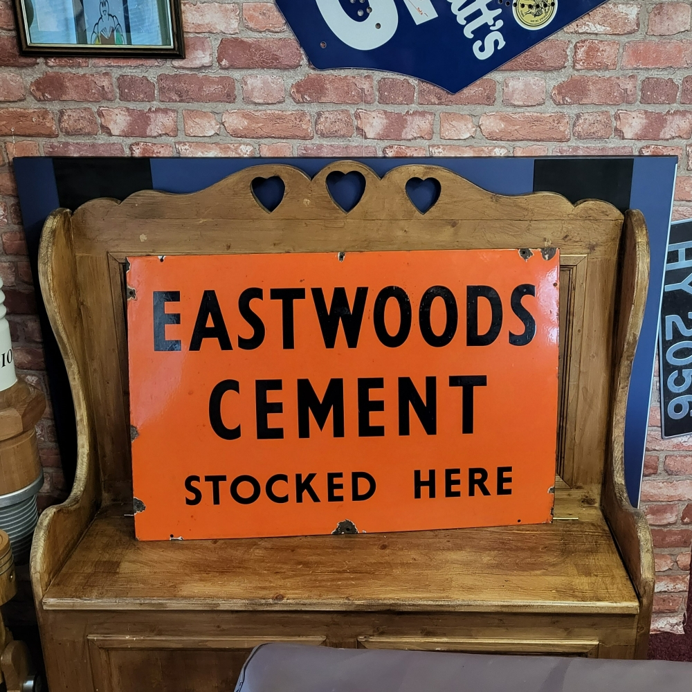 An Eastwoods Cement enamel sign 36 x 24 inches
